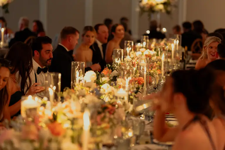 Guests dining by candlelight at a Charleston wedding reception